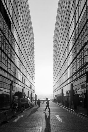 Silhouette of pedestrian under sunset in downtown districtの写真素材
