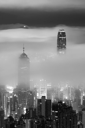 Night scenery of skyline of Hong Kong city in fogの写真素材