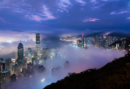 Night scenery of skyline of Hong Kong city in fogの写真素材