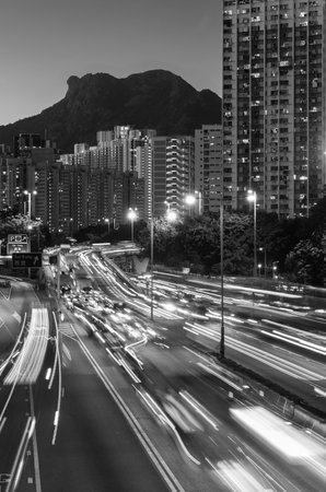 Natural landmark Mountain Lion Rock and traffic in Hong Kong cityの写真素材
