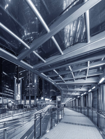 Night scenery of modern pedestrian walkway in downtown district of Hong Kong cityの写真素材