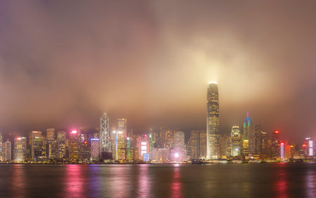 foggy night view of Victoria harbor in Hong Kong cityの写真素材