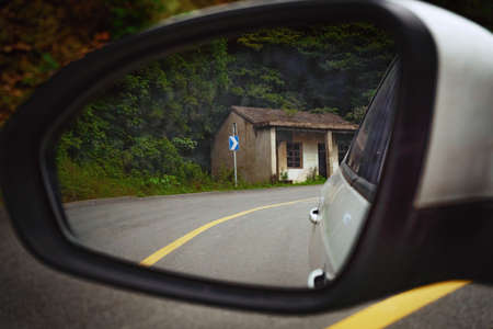 Lonely abandoned hut in the rearview mirror