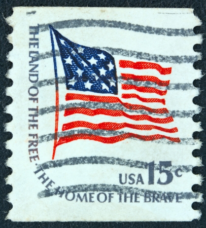 USA - CIRCA 1975: A stamp printed in USA from the "Americana" issue shows the Fort McHenry flag and the inscription "The Land of the Free-the Home of the Brave", circa 1975.のeditorial素材