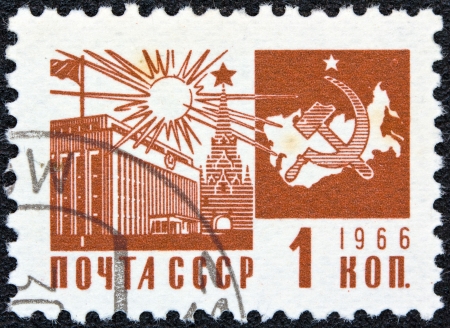 USSR - CIRCA 1966: A stamp printed in USSR from the "Society and Technology" issue shows the Palace of Congresses, Kremlin and communism emblem with map, circa 1966.のeditorial素材