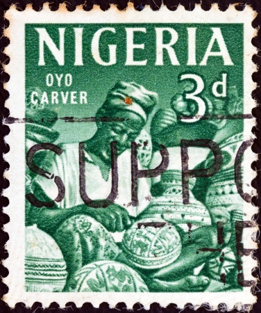 NIGERIA - CIRCA 1961: A stamp printed in Nigeria shows Oyo carver, circa 1961. のeditorial素材