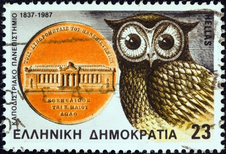 GREECE - CIRCA 1987: A stamp printed in Greece issued for the 150th anniversary of Athens University and National Metsovio Polytechnic Institute shows medal and owl, circa 1987. のeditorial素材