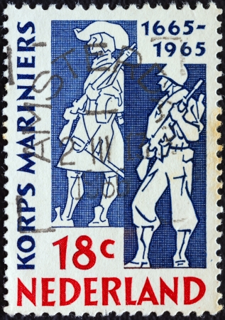 NETHERLANDS - CIRCA 1965: A stamp printed in the Netherlands issued for the tercentenary of Marine Corps shows Marines of 1665 and 1965, circa 1965. のeditorial素材