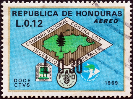 HONDURAS - CIRCA 1971: A stamp printed in Honduras shows Forest Fire Brigade emblem (with map of Honduras) and emblems of fire fighters, FAO and Alliance for Progress, circa 1971. のeditorial素材