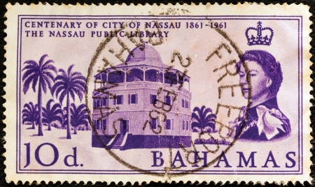 BAHAMAS - CIRCA 1961: A stamp printed in the Bahamas issued for the centenary of city of Nassau shows Nassau Public Library and Queen Elizabeth II, circa 1961. のeditorial素材