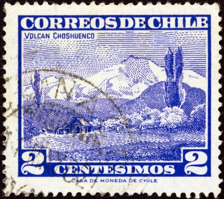 CHILE - CIRCA 1960: A stamp printed in Chile shows Choshuenco volcano, circa 1960. のeditorial素材