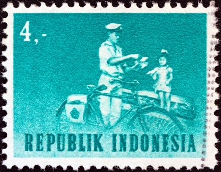 INDONESIA - CIRCA 1964: A stamp printed in Indonesia shows mailman with bicycle, circa 1964. のeditorial素材