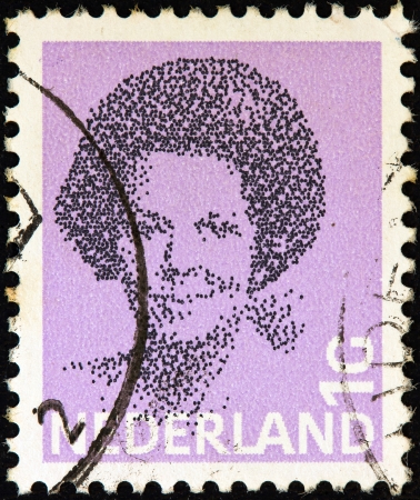 NETHERLANDS - CIRCA 1981: A stamp printed in the Netherlands shows a portrait of Queen Beatrix, circa 1981. のeditorial素材