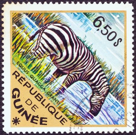 GUINEA - CIRCA 1975: A stamp printed in Guinea from the "Wild Animals" issue shows a Grantのeditorial素材