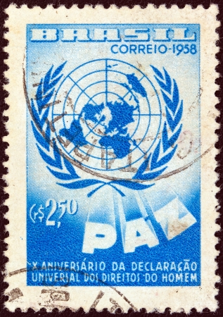 BRAZIL - CIRCA 1958: A stamp printed in Brazil issued for the 10th anniversary of human rights declaration shows United Nations emblem, circa 1958. のeditorial素材
