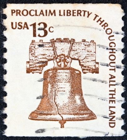 USA - CIRCA 1975: A stamp printed in USA from the "Americana" issue shows the Liberty Bell and the inscription "Proclaim Liberty Throughout All the Land", circa 1975. のeditorial素材