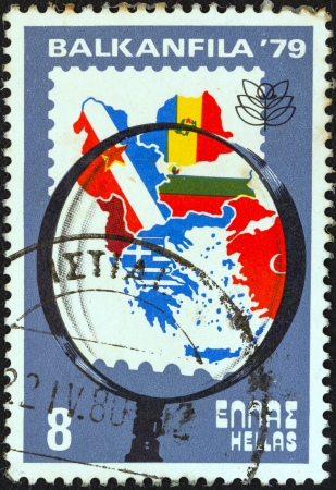 GREECE - CIRCA 1979: A stamp printed in Greece from the "Balkanfila '79 stamp exhibition" issue shows magnifying glass and map of Balkan countries, circa 1979. のeditorial素材