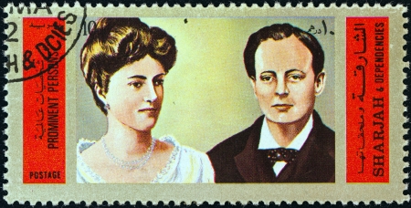 SHARJAH - CIRCA 1972: A stamp printed in United Arab Emirates shows Winston Churchill and Queen...