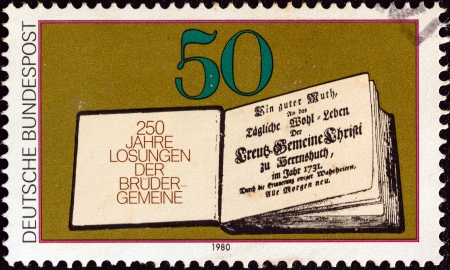GERMANY - CIRCA 1980: A stamp printed in Germany issued for the 250th anniversary of Moravian Brethren's Book of Daily Bible Readings shows First Book of Daily Bible Readings, 1731, circa 1980. のeditorial素材