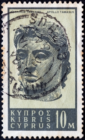 CYPRUS - CIRCA 1962: A stamp printed in Cyprus shows bronze head of god Apollo Tamasus, circa 1962. のeditorial素材
