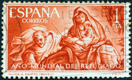 SPAIN - CIRCA 1961: A stamp printed in Spain from the "World Refugee Year" issue shows The Flight to Egypt (after Bayeu), circa 1961. のeditorial素材