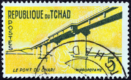 CHAD - CIRCA 1961: A stamp printed in Chad shows Chari Bridge and Hippopotamus, circa 1961. のeditorial素材