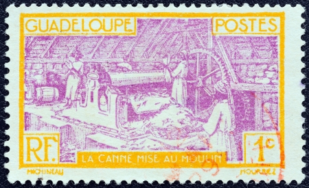GUADELOUPE - CIRCA 1928: A stamp printed in France shows Sugar Refinery, circa 1928. のeditorial素材