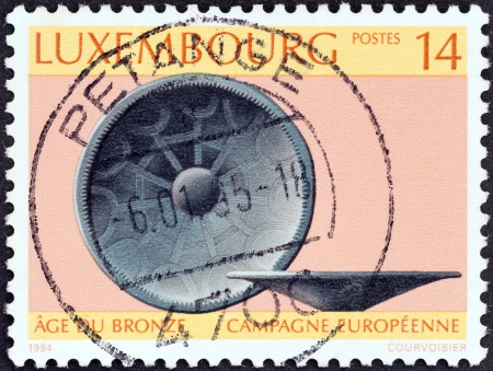 LUXEMBOURG - CIRCA 1994: A stamp printed in Luxembourg issued for the European Bronze Age Research Campaign shows Bronze Age bowl, circa 1994.のeditorial素材