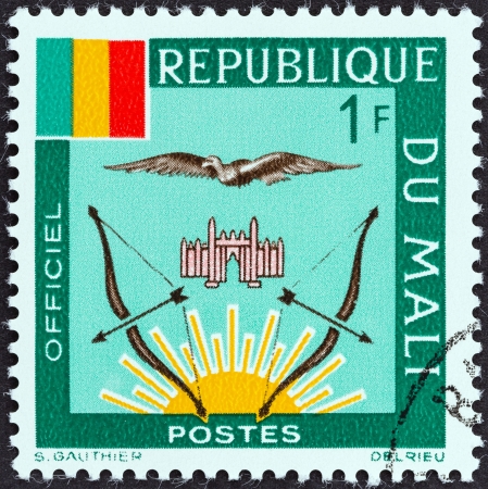 MALI - CIRCA 1964: A stamp printed in Mali shows Mali Flag and Emblems, circa 1964. のeditorial素材