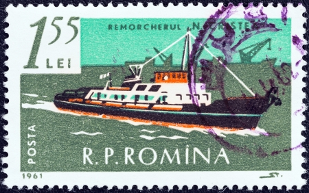 ROMANIA - CIRCA 1961: A stamp printed in Romania from the \"Merchant Navy\" issue shows tug N. Cristea, circa 1961. のeditorial素材