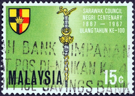 MALAYSIA - CIRCA 1967: A stamp printed in Malaysia from the \"Centenary of Sarawak Council\" issue shows Mace and Shield, circa 1967.のeditorial素材