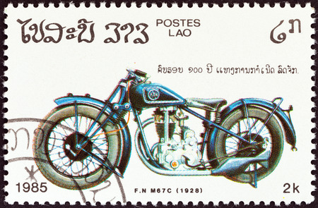 LAOS - CIRCA 1985  A stamp printed in Laos from the  Centenary of Motorcycle   issue shows a F N  M67C, 1928, circa 1985  のeditorial素材