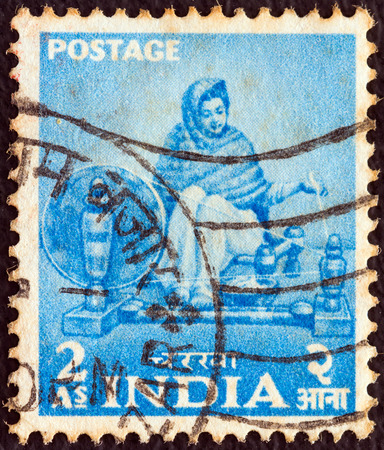 INDIA - CIRCA 1955  A stamp printed in India from the  Five Year Plan  issue shows a woman spinning, circa 1955  のeditorial素材