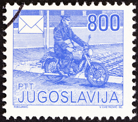 YUGOSLAVIA - CIRCA 1986: A stamp printed in Yugoslavia from the \\\"Postal Services\\\" issue shows Postman on motorcycle, circa 1986.のeditorial素材