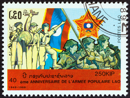 LAOS - CIRCA 1989: A stamp printed in Laos from the \"40th anniversary of People\'s Army \" issue shows peasant, revolutionary, worker and soldiers, circa 1989.のeditorial素材