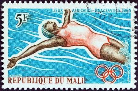 MALI - CIRCA 1965: A stamp printed in Mali from the \\\\\\\"1st African Games, Brazzaville\\\\\\\" issue shows backstroke swimmer, circa 1965.のeditorial素材