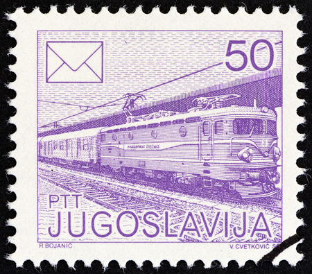 YUGOSLAVIA - CIRCA 1986: A stamp printed in Yugoslavia from the \"Postal Services\" issue shows Electric train, circa 1986.のeditorial素材