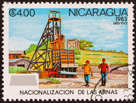 NICARAGUA - CIRCA 1983: A stamp printed in Nicaragua from the \\\"Nationalization of Mines \\\" issue shows workers and mine, circa 1983.のeditorial素材