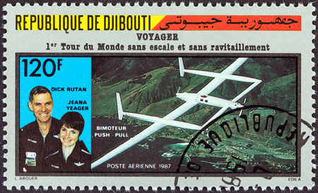 DJIBOUTI - CIRCA 1987: A stamp printed in Djibouti issued for the first flight around the world without stopping or refueling by Rutan Model 76 Voyager shows Dick Rutan and Jeana Yeager, circa 1987.のeditorial素材