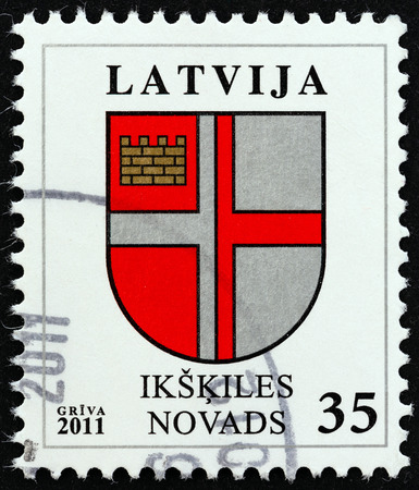 LATVIA  CIRCA 2011: A stamp printed in Latvia from the "Coat of Arms " issue shows Coat of Arms of Ikskiles circa 2011.のeditorial素材