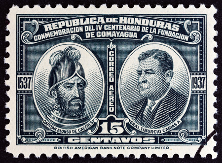 HONDURAS  CIRCA 1937: A stamp printed in Honduras issued for the 400th anniversary of Comayagua shows Alonso de Caceres and Tiburcio Carias Andino circa 1937.のeditorial素材