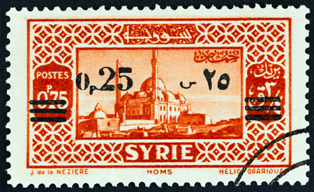 SYRIA - CIRCA 1938: A stamp printed in Syria shows Homs, circa 1938.のeditorial素材