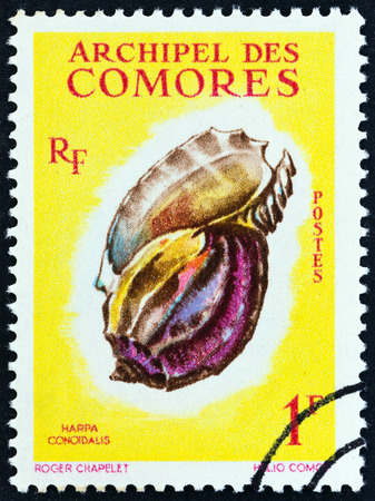 COMOROS - CIRCA 1962: A stamp printed in Comoros from the "Sea Shells" issue shows Harpa major (Harpa conoidalis), circa 1962.のeditorial素材