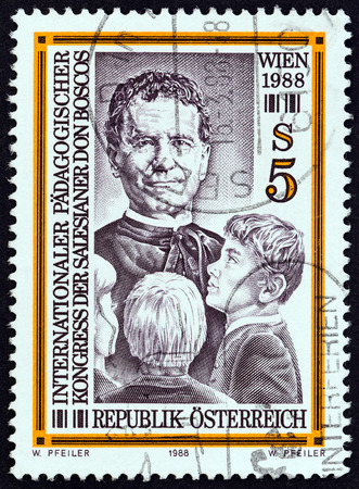AUSTRIA - CIRCA 1988: A stamp printed in Austria issued for the International Educational Congress of St. John Bosco's Salesian Brothers, Vienna shows Bosco and Boys, circa 1988.のeditorial素材