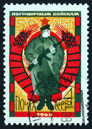USSR - CIRCA 1968: A stamp printed in USSR issued for the 50th anniversary of Soviet Frontier Guards shows Frontier Guard, circa 1968.のeditorial素材