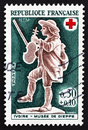 FRANCE - CIRCA 1967: A stamp printed in France from the Red Cross Fund. Ivories in Dieppe Museum issue shows Violinist, circa 1967.のeditorial素材