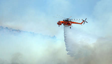 Athens, Greece, June 4, 2022: A firefighting Erickson S-64 Aircrane helicopter operates in Hymettus...