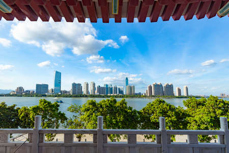 View the high-rise buildings across the river from the Hejiang Tower Scenic Area in Huizhouのeditorial素材