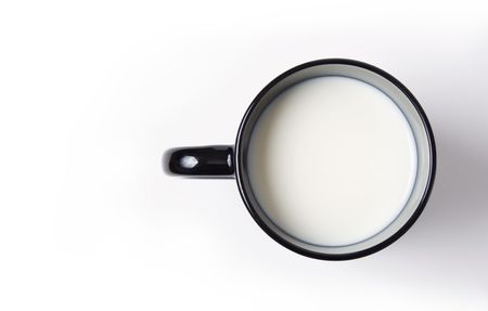 Black cup filled with milk top view isolated on white backgroundの写真素材