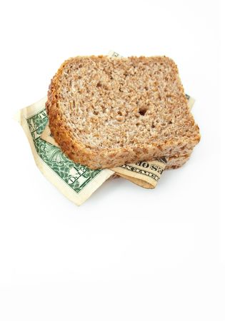 	Dollar banknotes between two slices of wholemeal bread isolated on white backgroundの写真素材